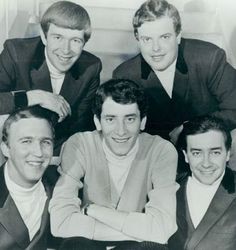 four men are posing for a black and white photo