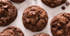 chocolate chip cookies are arranged on a white surface