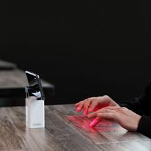 a woman is sitting at a table with her hand on the edge