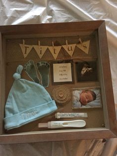 a baby's birth gift set in a shadow box