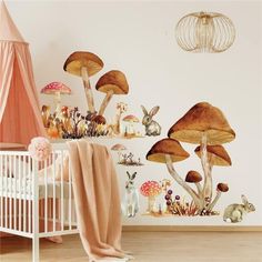 a baby's room with mushrooms and rabbits on the wall, along with a crib