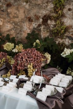 there are many grapes on the table with place cards