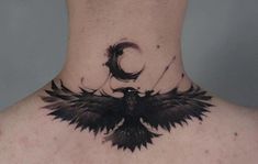 the back of a man's neck with a black bird tattoo on his chest