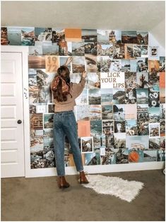 a woman standing in front of a wall with pictures on it