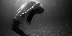 a woman is diving in the water with her head above the water's surface