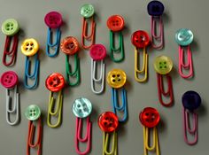 many different colored paper clips with buttons on them