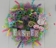 a colorful wreath with the word easter written on it and an image of a bunny