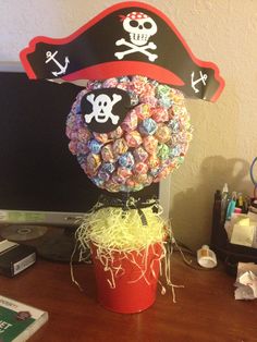 a computer desk with a pirate candy bouquet on it