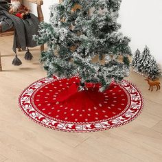 a small christmas tree sitting on top of a red rug