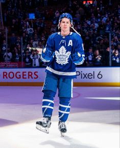 a hockey player is walking on the ice