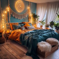 a bedroom with blue walls and lights on the headboard is decorated in gold, teal, and white