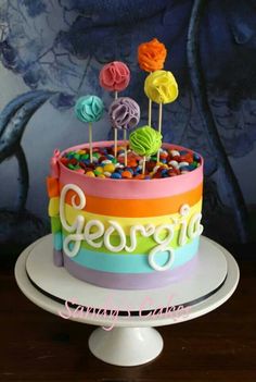 there is a cake decorated with candy and lollipops