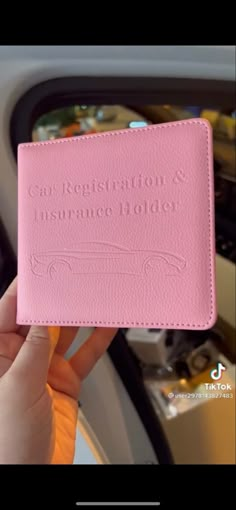 someone is holding up a pink card case with the words congratulations in white lettering on it