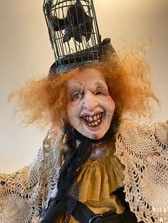 a creepy doll with a birdcage on top of it's head and hair