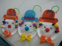 three paper plates with clown faces and hats on them, all decorated in different colors