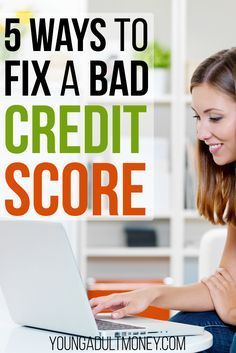 a woman sitting on the floor with her laptop and credit card in front of her