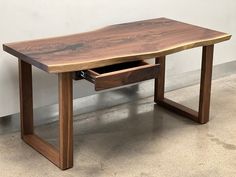 a wooden table with two drawers underneath it