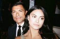 a man standing next to a woman at a formal event