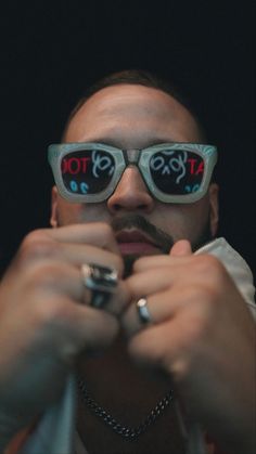 a man wearing glasses with the word stop written on them