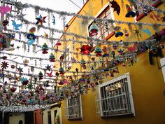 many ornaments are hanging from the side of a building