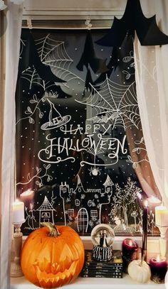 a window decorated with halloween decorations and candles