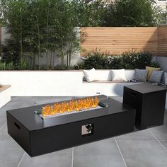 an outdoor fire pit sitting on top of a patio