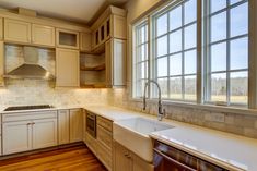 an empty kitchen with white cabinets and wood flooring is pictured in this image from the inside