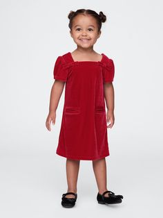 Soft, stretch velour dress.  Square neck with back button closures.  Short puff sleeves.  Bow details at front.  Front welt pockets.  This dress is made with 95% recycled polyester.  Compared to virgin materials, using recycled materials helps to reduce resource use and waste.  Shift silhouette with an easy fit.  Hits at the knee.  Sizes range from baby to toddler. Christmas Party Attire, Toddler Christmas Dress, Dress Square Neck, Party Attire, Velour Dress, Chunky Knitwear, Newborn Dresses, Wide Fit Boots, Set Outfit