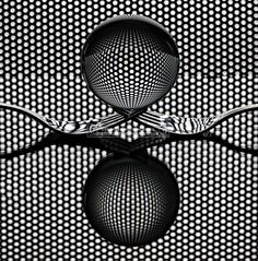 an abstract black and white photo with circles in the center, reflecting on top of it