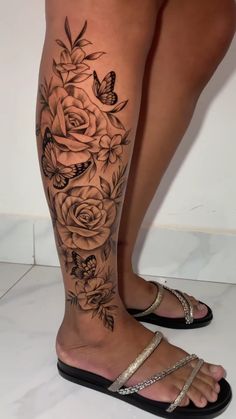 a woman's legs with flowers and butterflies on them