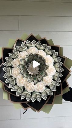 a flower made out of money sitting on top of a wall