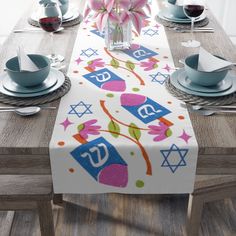 the table is set with plates, cups and utensils for jewish holiday celebrations