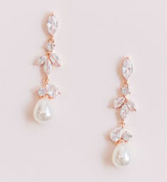 Luminous pearl drop wedding earrings designed with cascading crystals and a teardrop pearl. Cubic zirconia crystals Available in rose gold and silver Length: 1.5" FAQ: How long does it take for my order to be shipped and when will it arrive? It usually takes 2-3 business days for your order to be processed and shipped. Please email us directly or by using the contact form if you need your order rushed. Priority shipping does not rush processing and shipping times, only the time it takes for your Bride Earrings Gold, Beach Wedding Earrings, Wedding Day Earrings, Wedding Earrings Bride, Wedding Earrings Silver, Rose Gold Earrings Wedding, Rose Gold Bridal Jewelry, Pearl Wedding Earrings, Silver Earrings Wedding