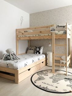 a child's bedroom with two bunk beds and a teddy bear rug on the floor