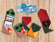 several different colored ties laid out next to each other on top of a wooden table