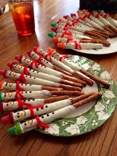 several decorated christmas crackers are on a green and white plate