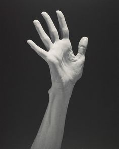 a black and white photo of a hand holding something