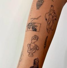 a woman's arm with various tattoos on it