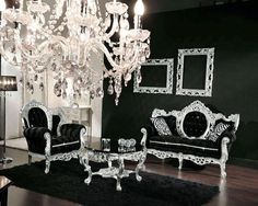 a fancy living room with chandelier and couches in black and white colors