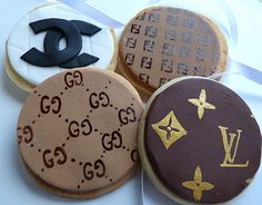 four decorated cookies are sitting on a table