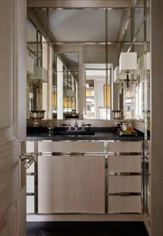 the interior of a bathroom with mirrors and lights