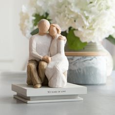 a figurine of two people sitting next to each other