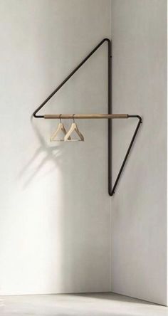 two clothes hangers are hanging on the wall