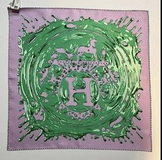 a green and purple painting on a white wall next to a light pink square with the letter e in it