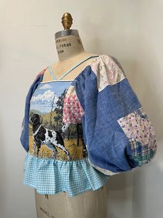 a mannequin wearing a blue and white top with an image of a cow on it