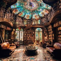 an ornate library with stained glass windows and lots of bookshelves, leather couches and tables