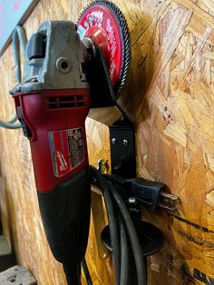 a corded driller is hooked up to a wall with a power tool attached