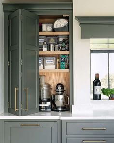 an open cabinet in the middle of a kitchen