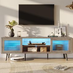 an entertainment center in the living room with a large screen tv on it's wall