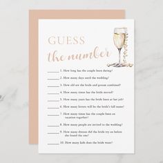 a card with the words guess the number and a glass of champagne on top of it